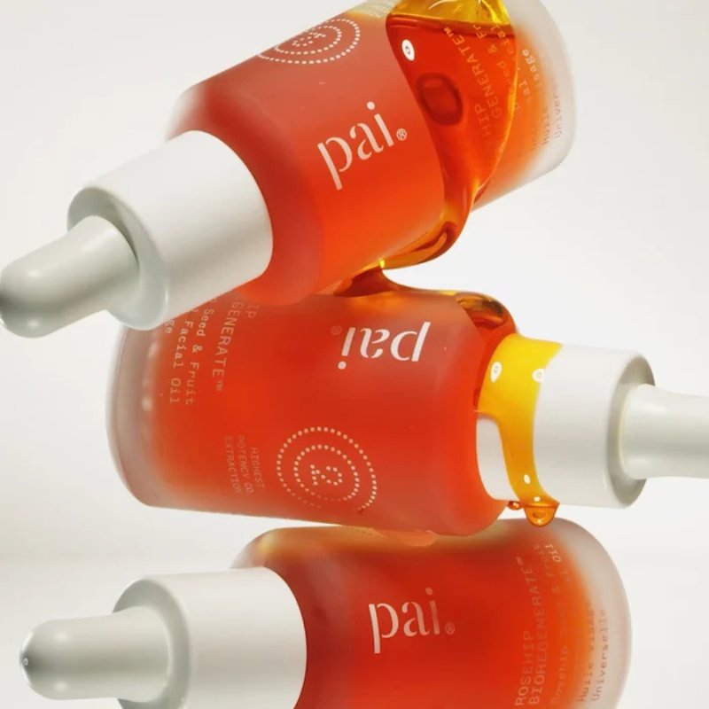 Pai Skincare Rosehip BioRegenerate oil bottle on a wooden surface with organic leaves - Mimosa Organic Care